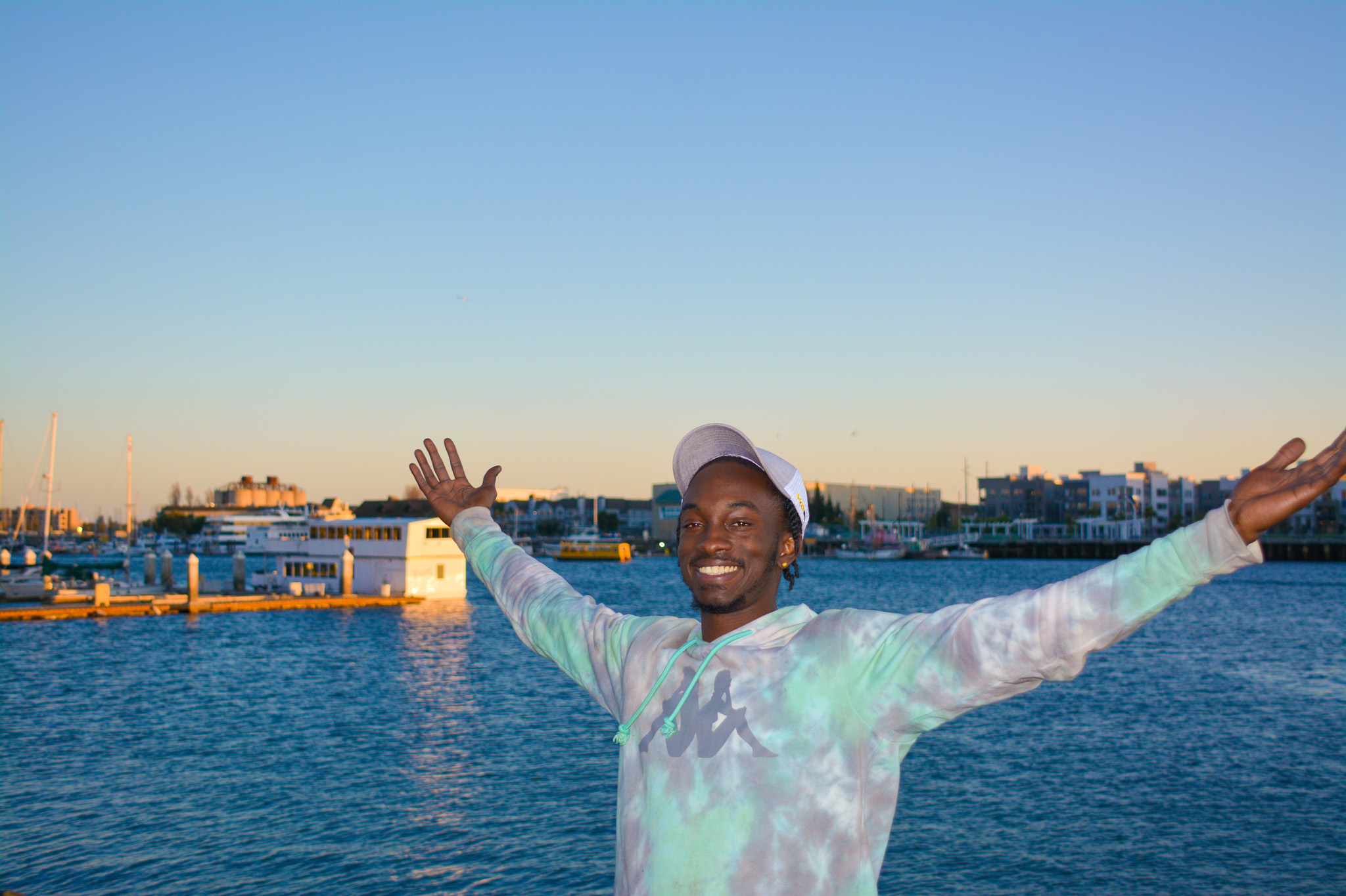 Geon, Youth Alive client, holding his arms out and smiling.