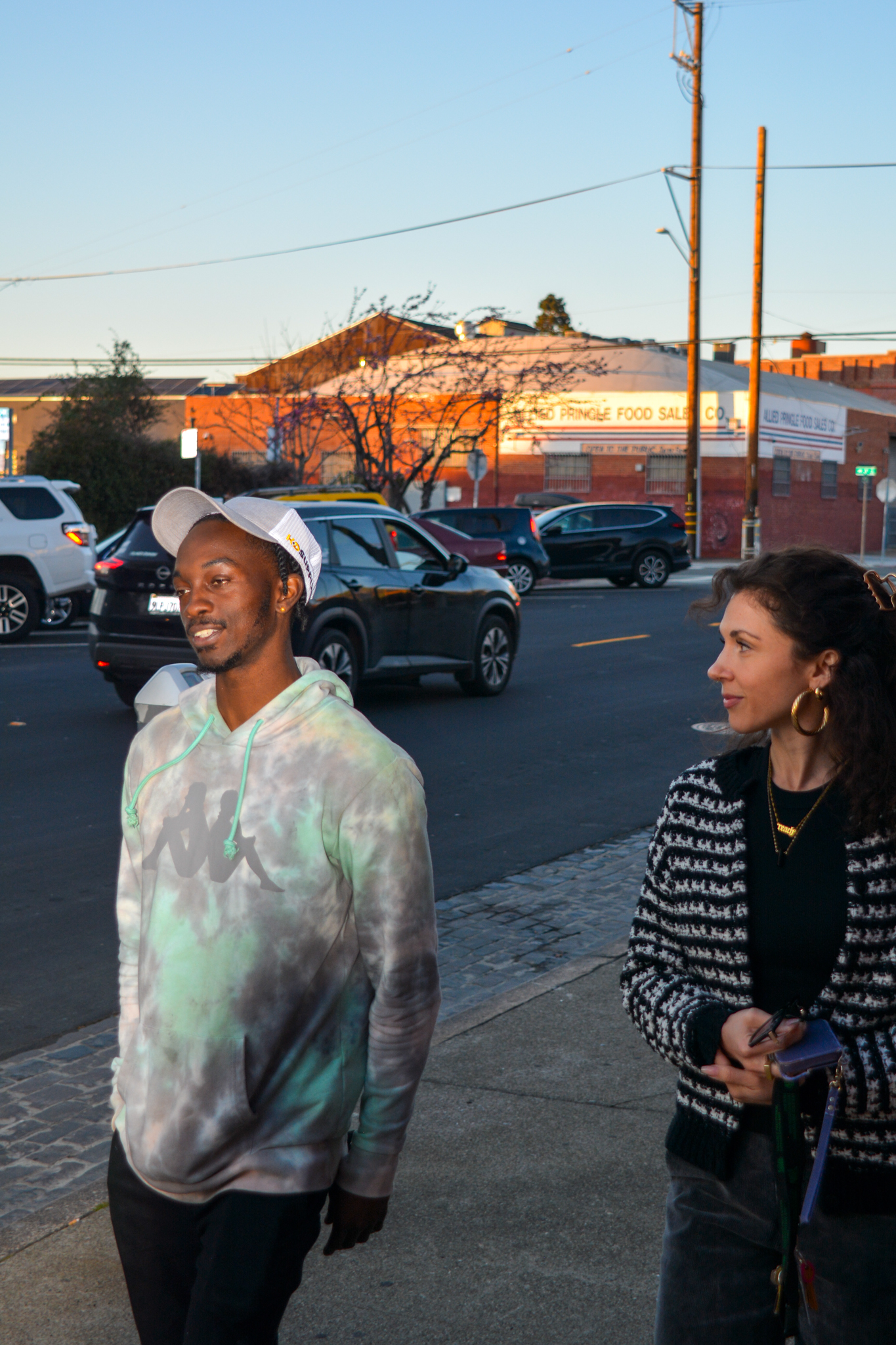 A photo of Geon, Youth Alive client, Rhea, his Youth Alive counselor, walking through Oakland.