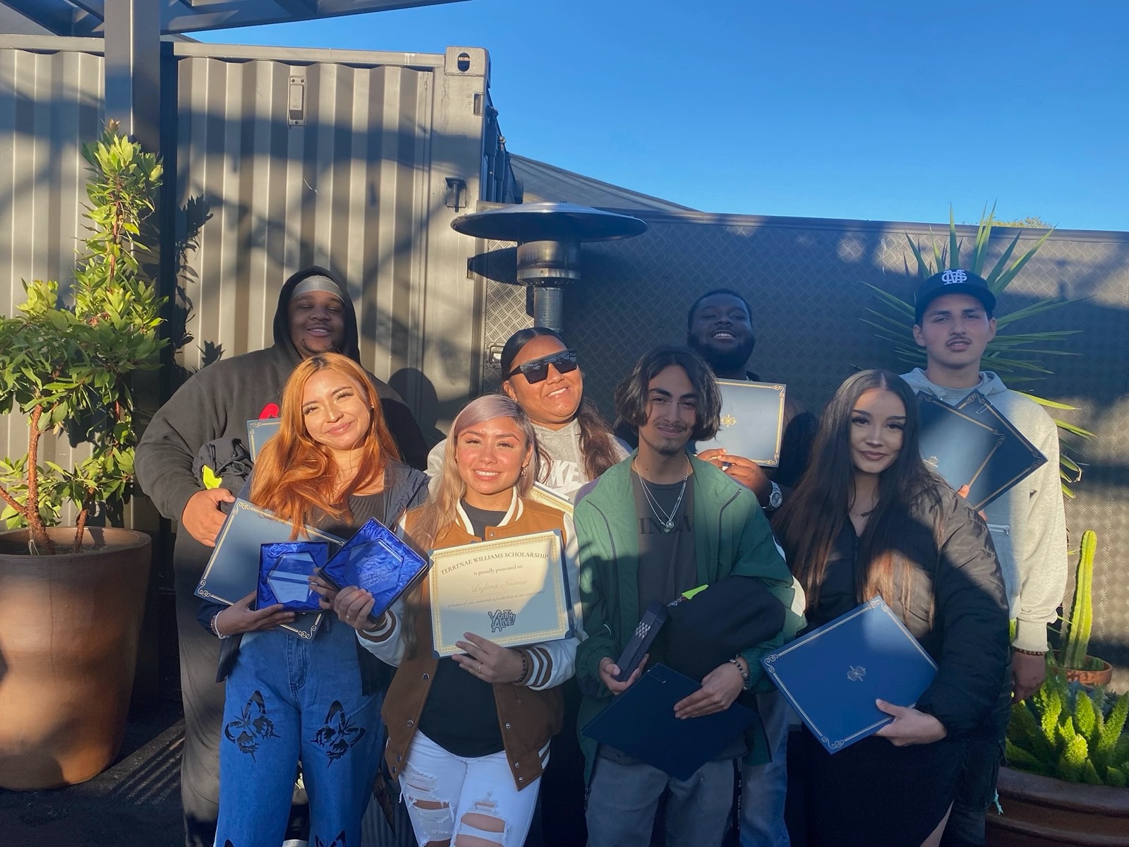 Princess and Teens on Target students from Castlemont High with their diplomas.